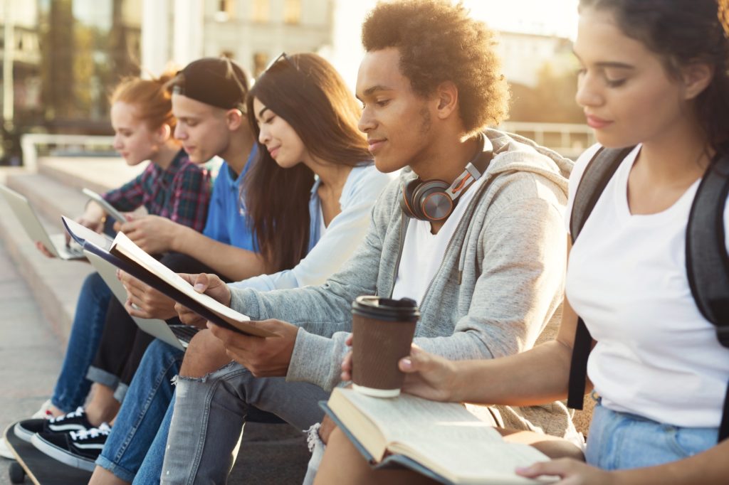Teenage Diverse Students Studying Outdoors in Evening